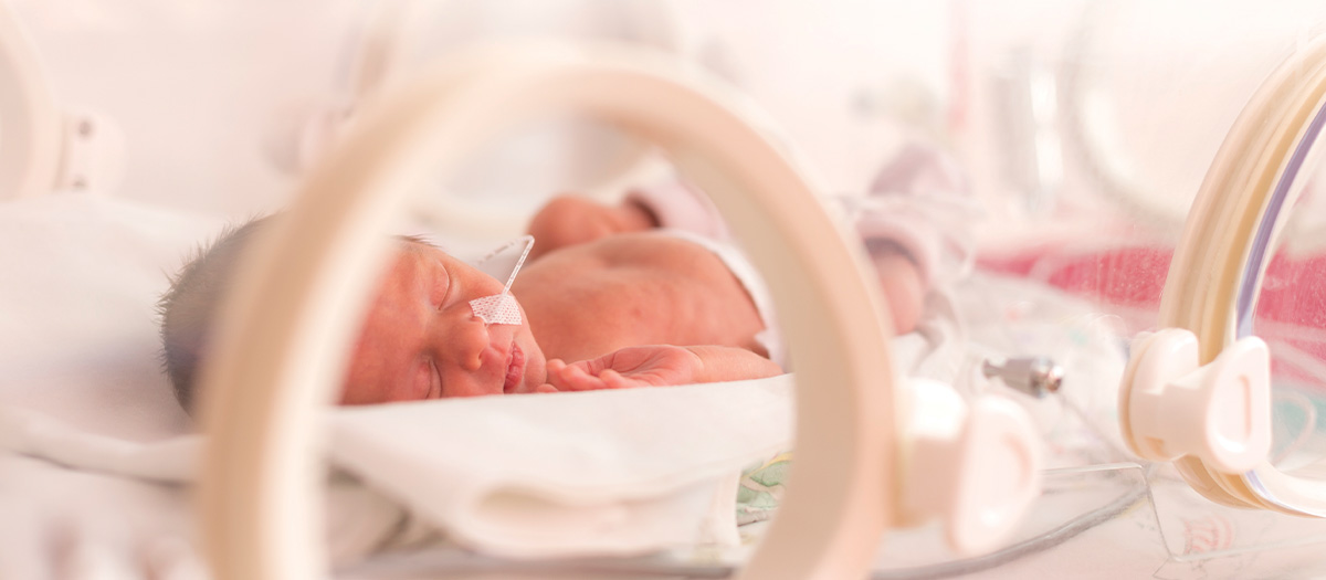 Baby in a NICU bed